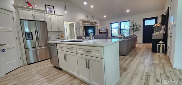 a kitchen with white cabinets and stainless steel appliances