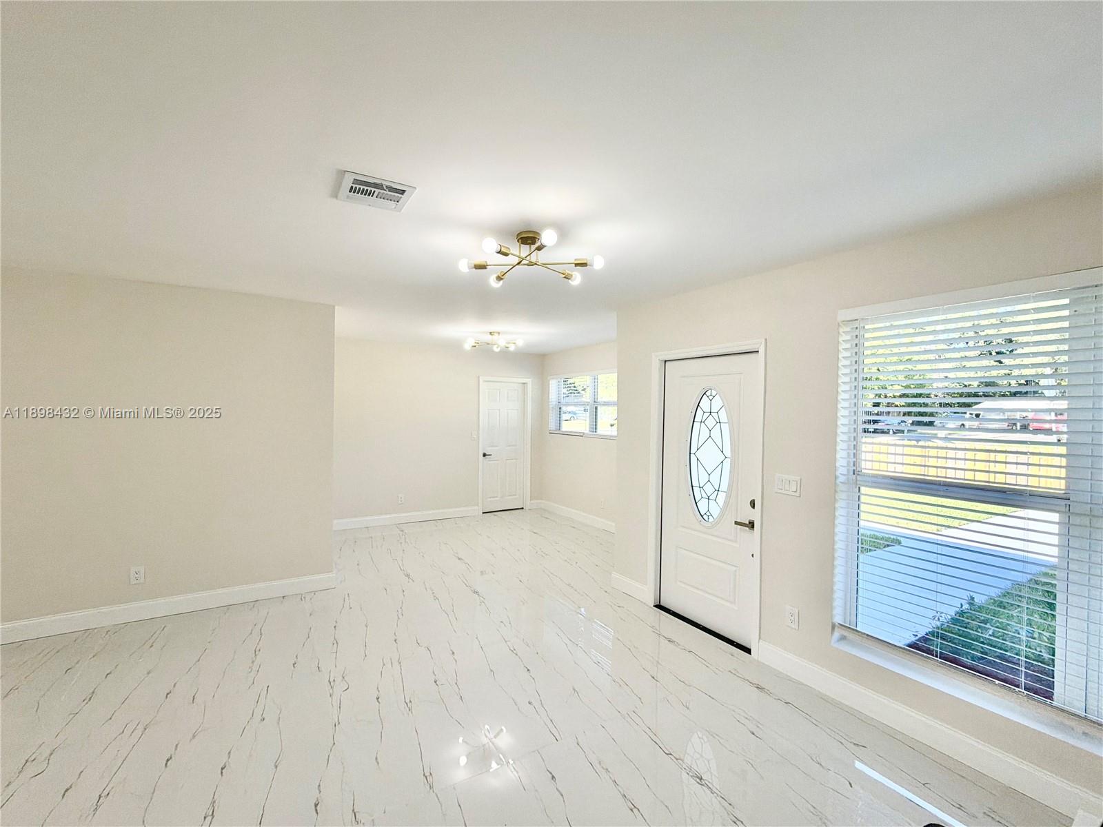 124 Harvard Road West Park, FL 33023 - Photo 11 of 75 wooden floor in an empty room with a window