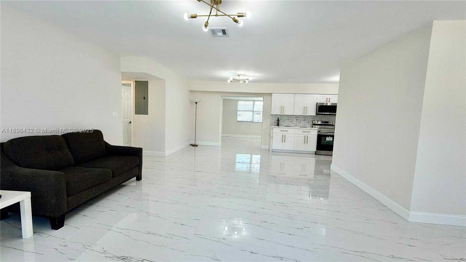 124 Harvard Road West Park, FL 33023 - Photo 16 of 75 a living room with stainless steel appliances kitchen island granite countertop furniture and a view of kitchen