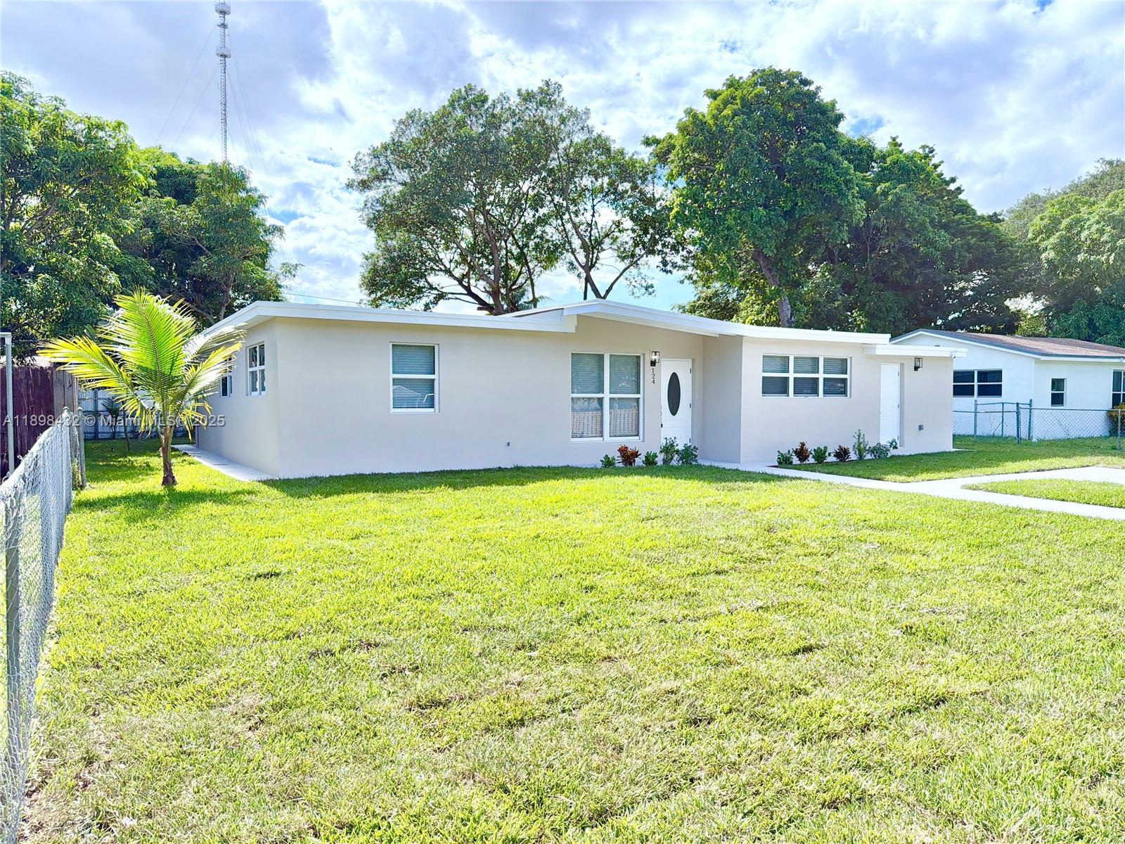 124 Harvard Road West Park, FL 33023 - Photo 2 of 75 a house view with swimming pool in front of it