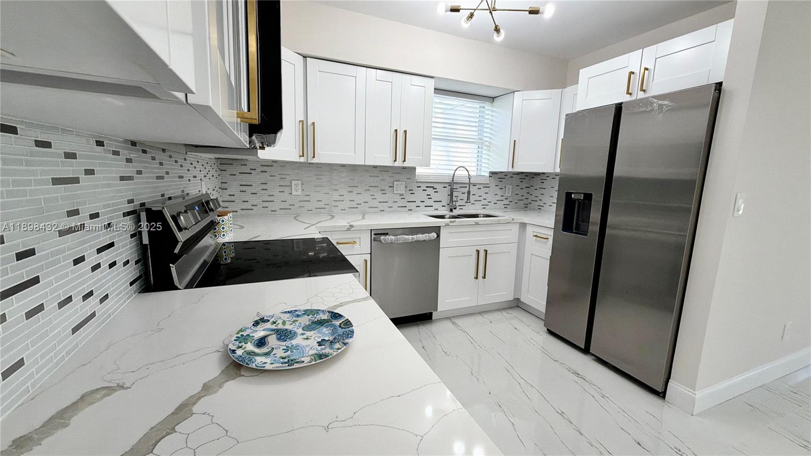 124 Harvard Road West Park, FL 33023 - Photo 26 of 75 a kitchen with stainless steel appliances a refrigerator sink and microwave