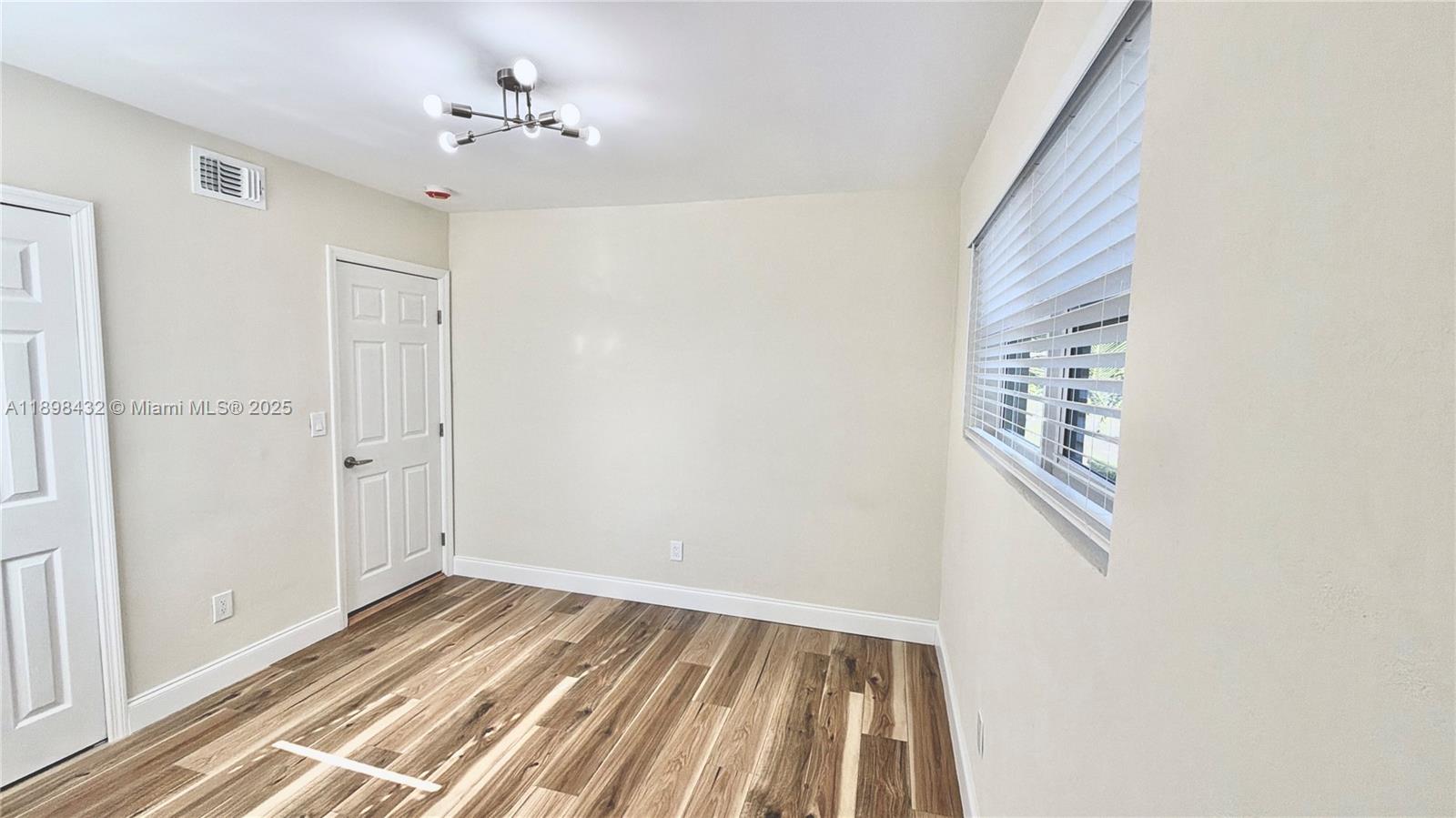 124 Harvard Road West Park, FL 33023 - Photo 32 of 75 a view of a room with wooden floor and fan