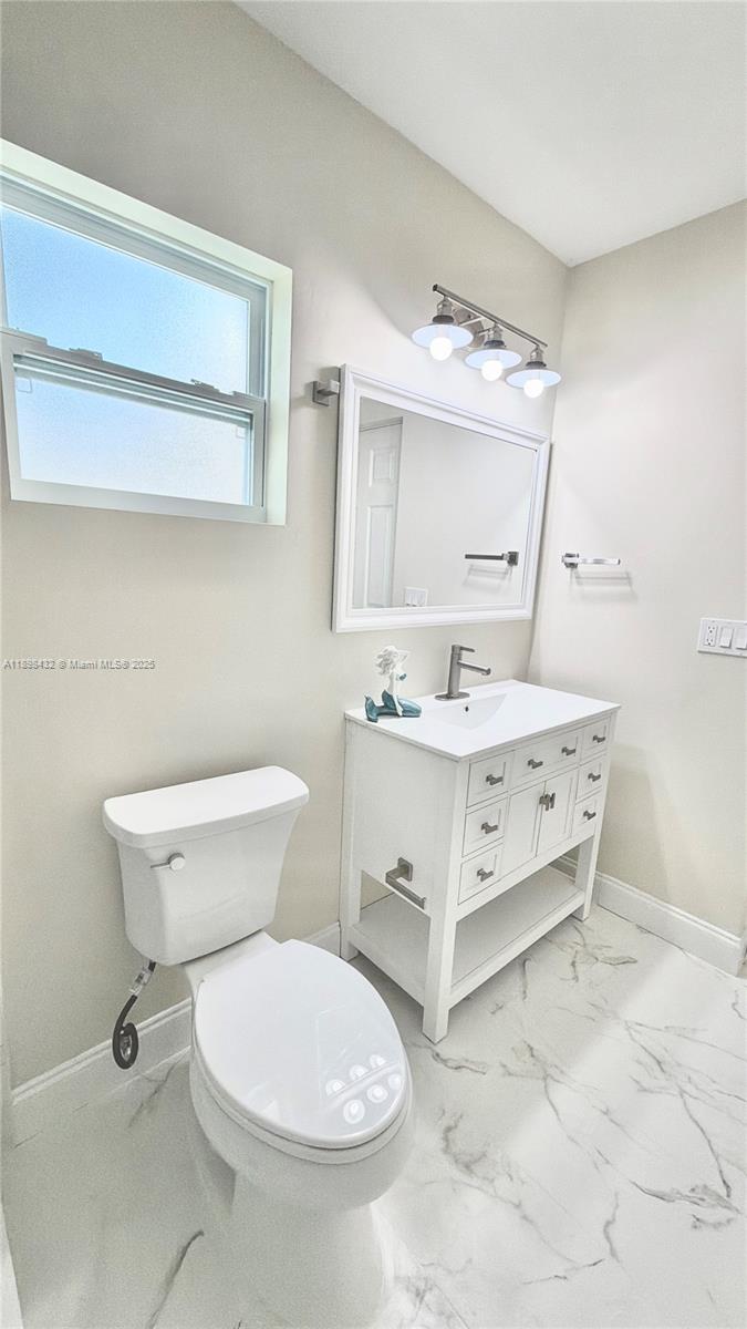 124 Harvard Road West Park, FL 33023 - Photo 34 of 75 a bathroom with a sink toilet and mirror