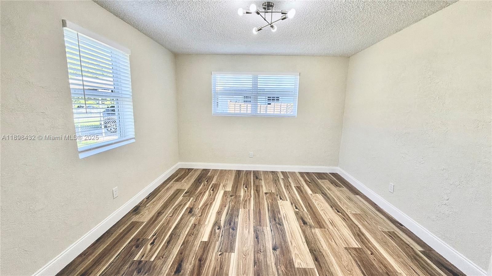124 Harvard Road West Park, FL 33023 - Photo 36 of 75 a view of a room with wooden floor and fan