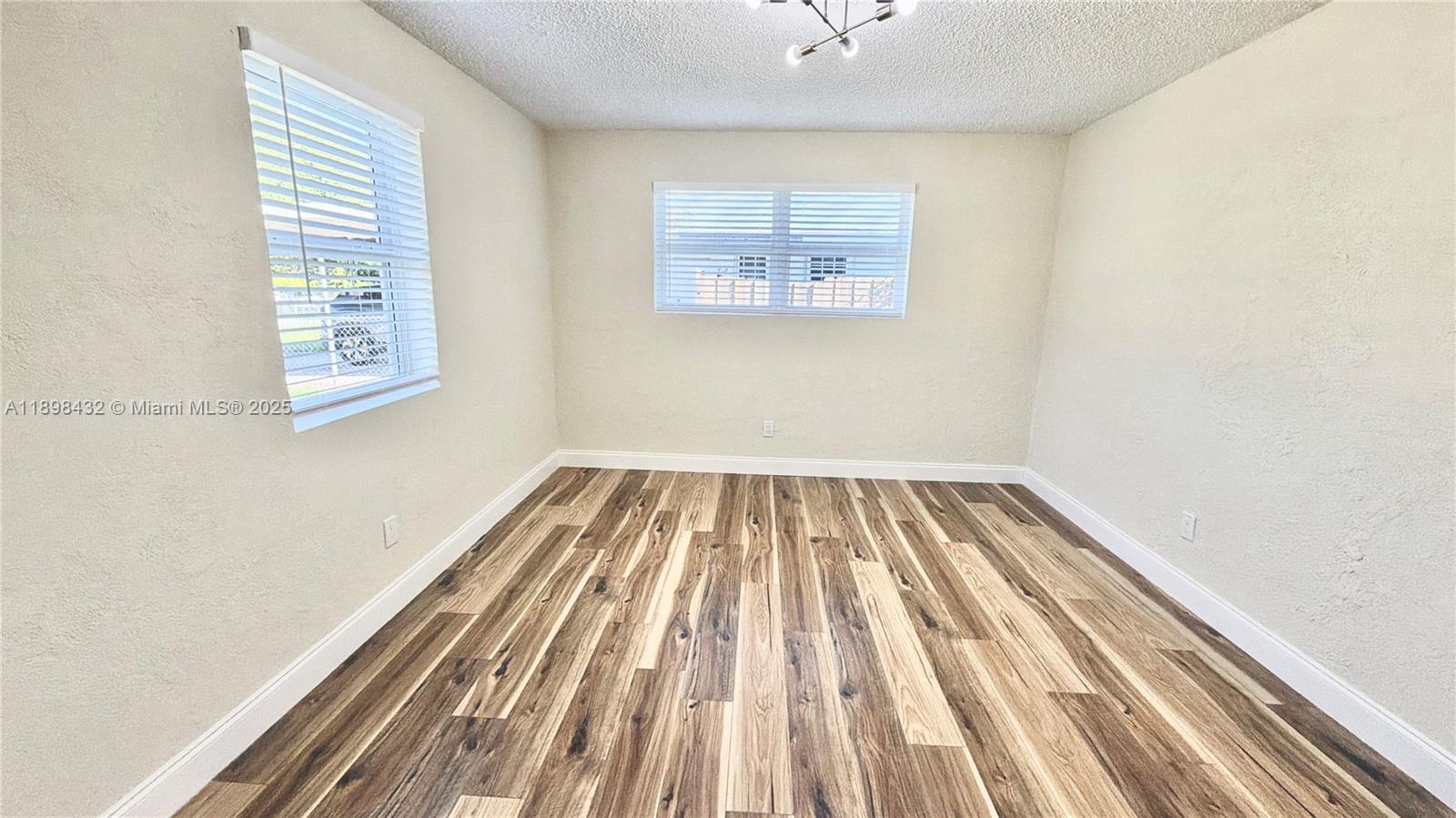 124 Harvard Road West Park, FL 33023 - Photo 37 of 75 a view of a room with wooden floor and a window