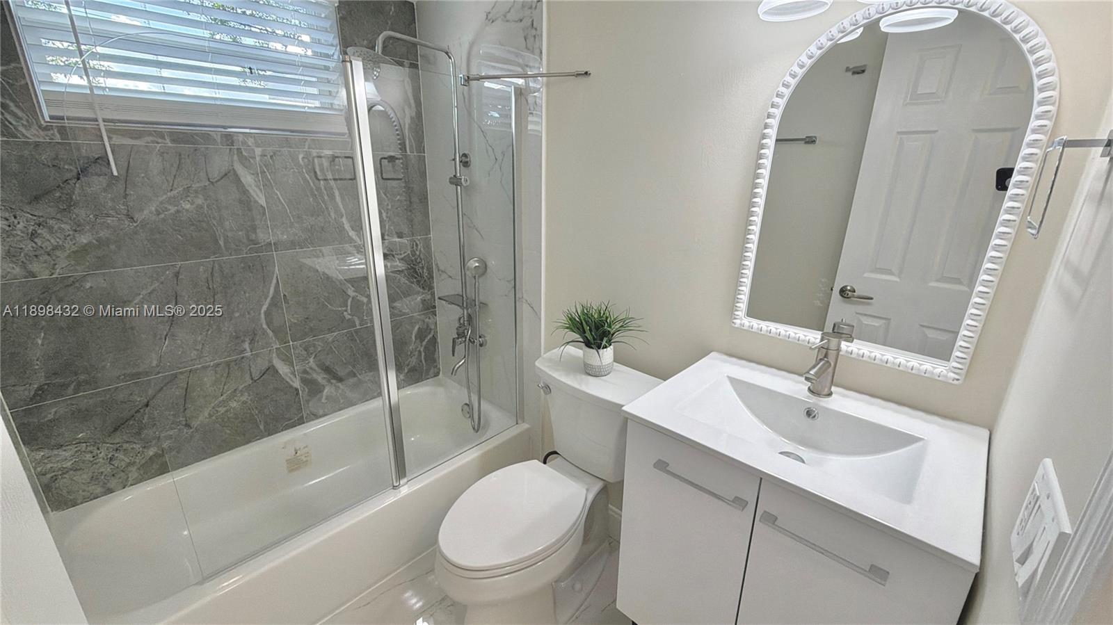 124 Harvard Road West Park, FL 33023 - Photo 40 of 75 a bathroom with a sink toilet and shower