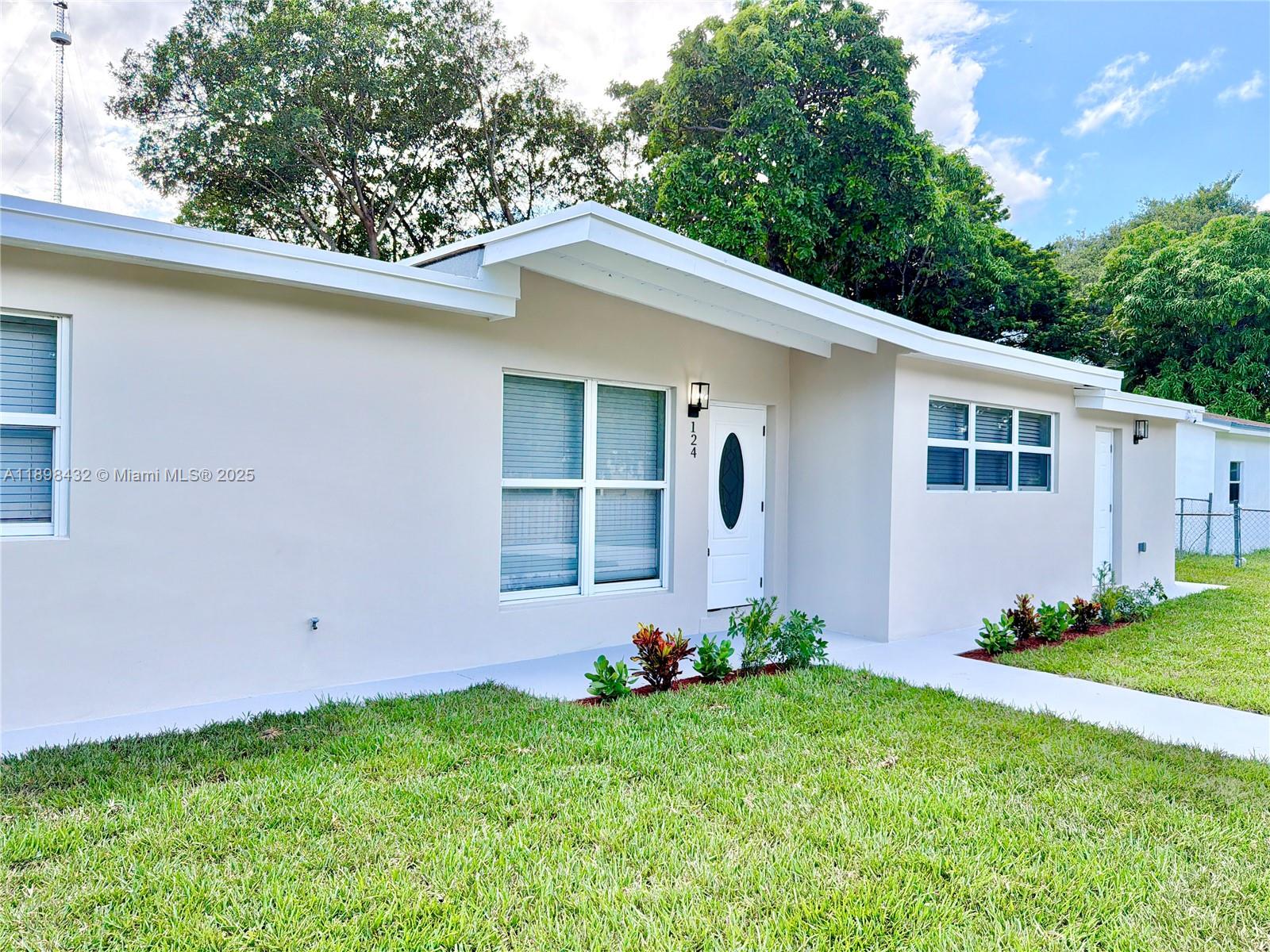 124 Harvard Road West Park, FL 33023 - Photo 4 of 75 a backyard of a house with lots of green space