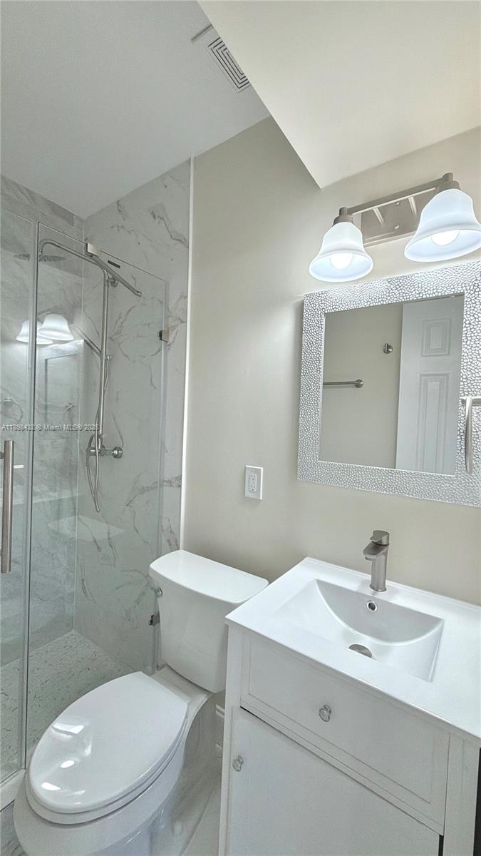 124 Harvard Road West Park, FL 33023 - Photo 48 of 75 a bathroom with a sink a toilet and shower