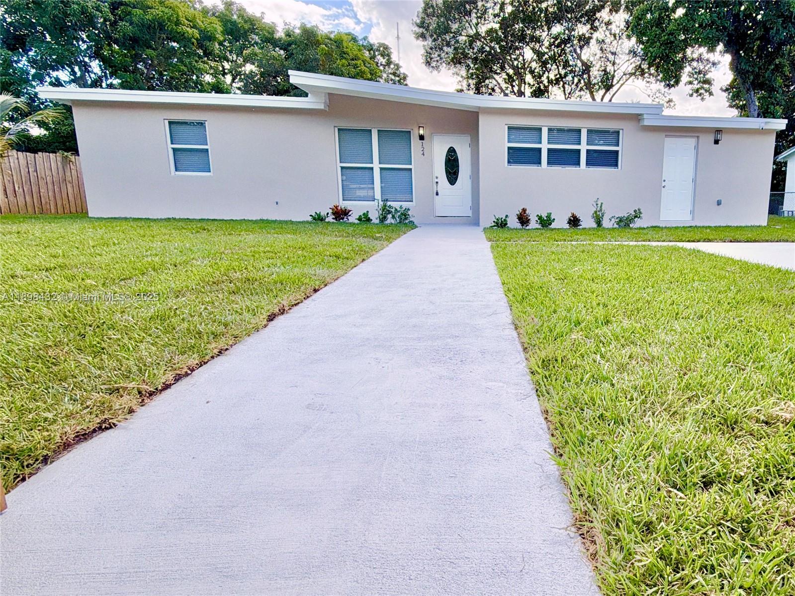 124 Harvard Road West Park, FL 33023 - Photo 5 of 75 a view of a backyard with a garden