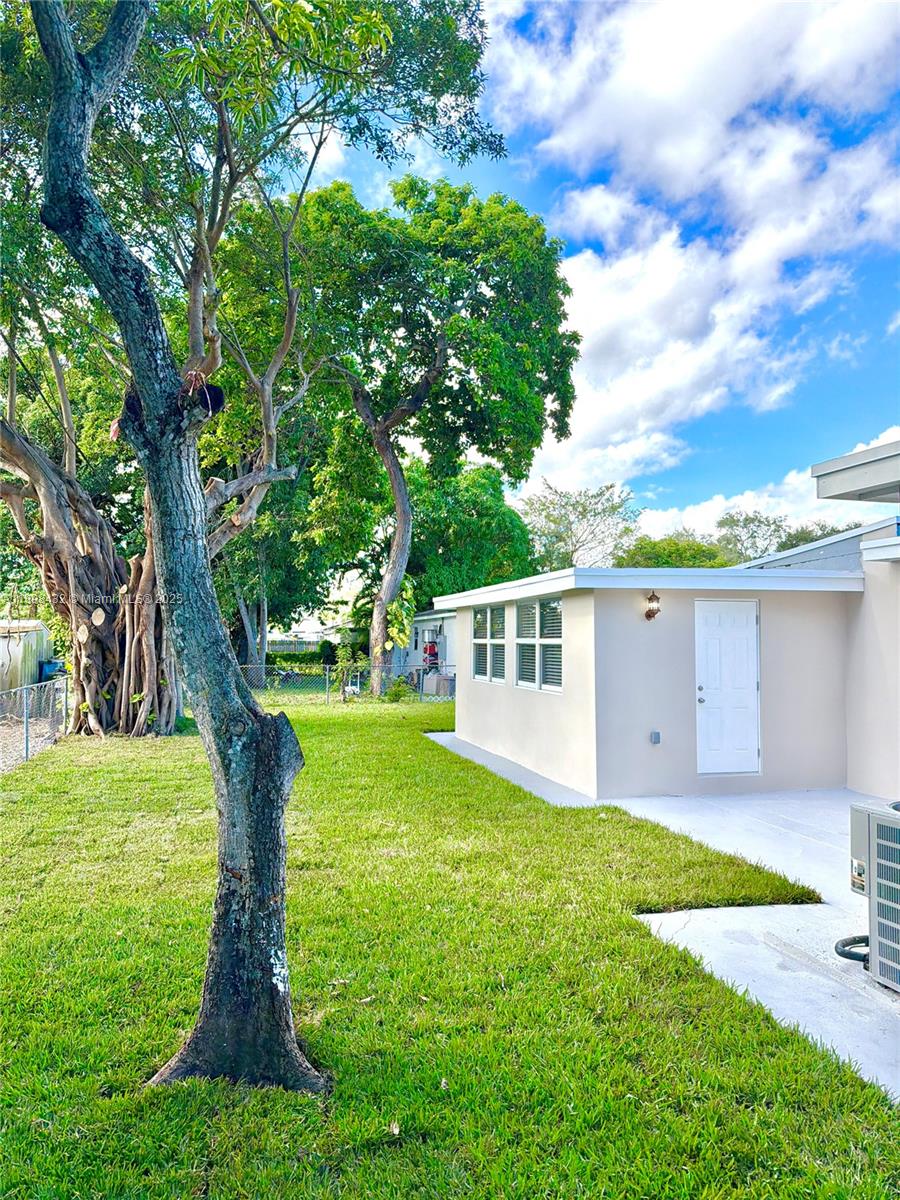 124 Harvard Road West Park, FL 33023 - Photo 54 of 75 a front view of a house with garden