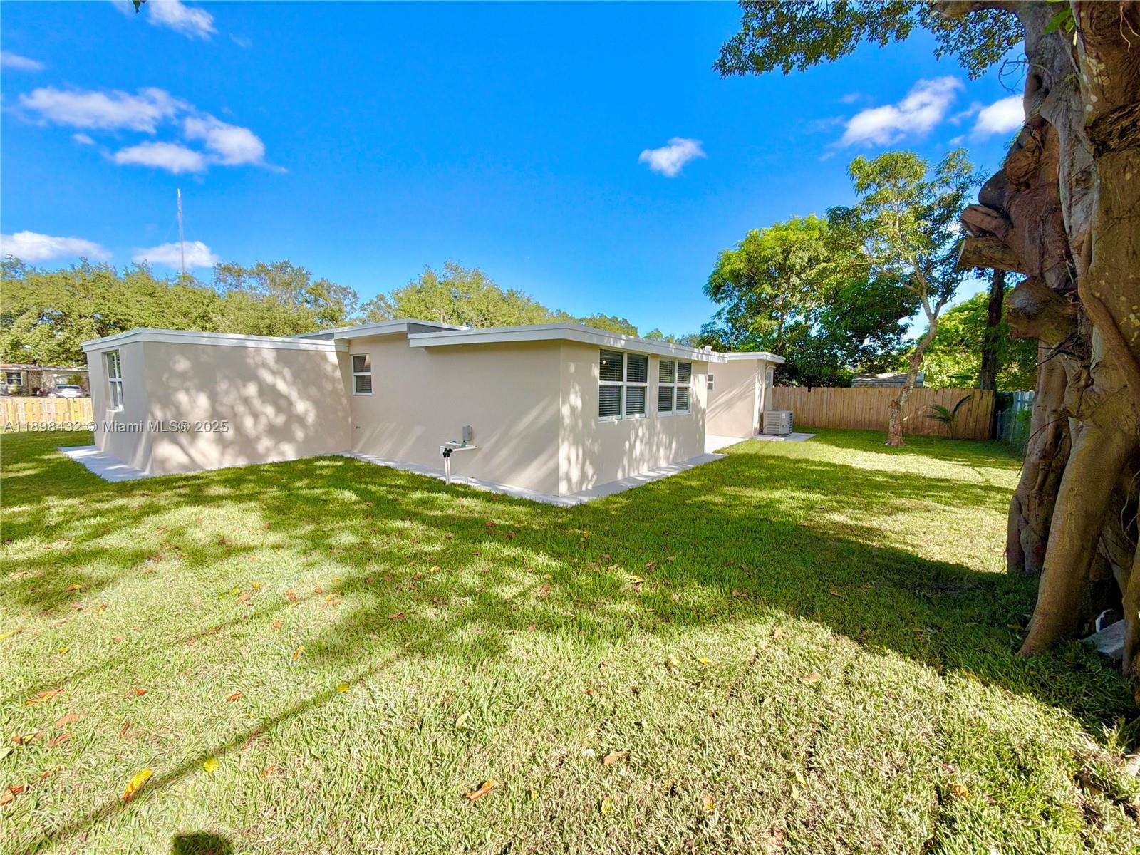 124 Harvard Road West Park, FL 33023 - Photo 55 of 75 a view of a house with a backyard and a patio