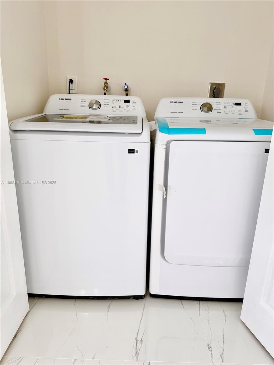124 Harvard Road West Park, FL 33023 - Photo 63 of 75 a utility room with dryer and washer
