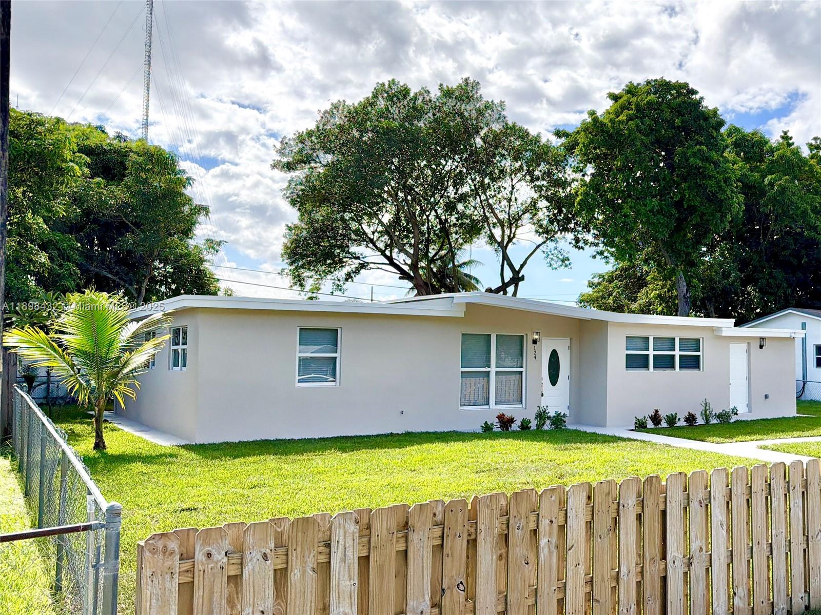 124 Harvard Road West Park, FL 33023 - Photo 69 of 75 a view of a house with a yard and sitting area