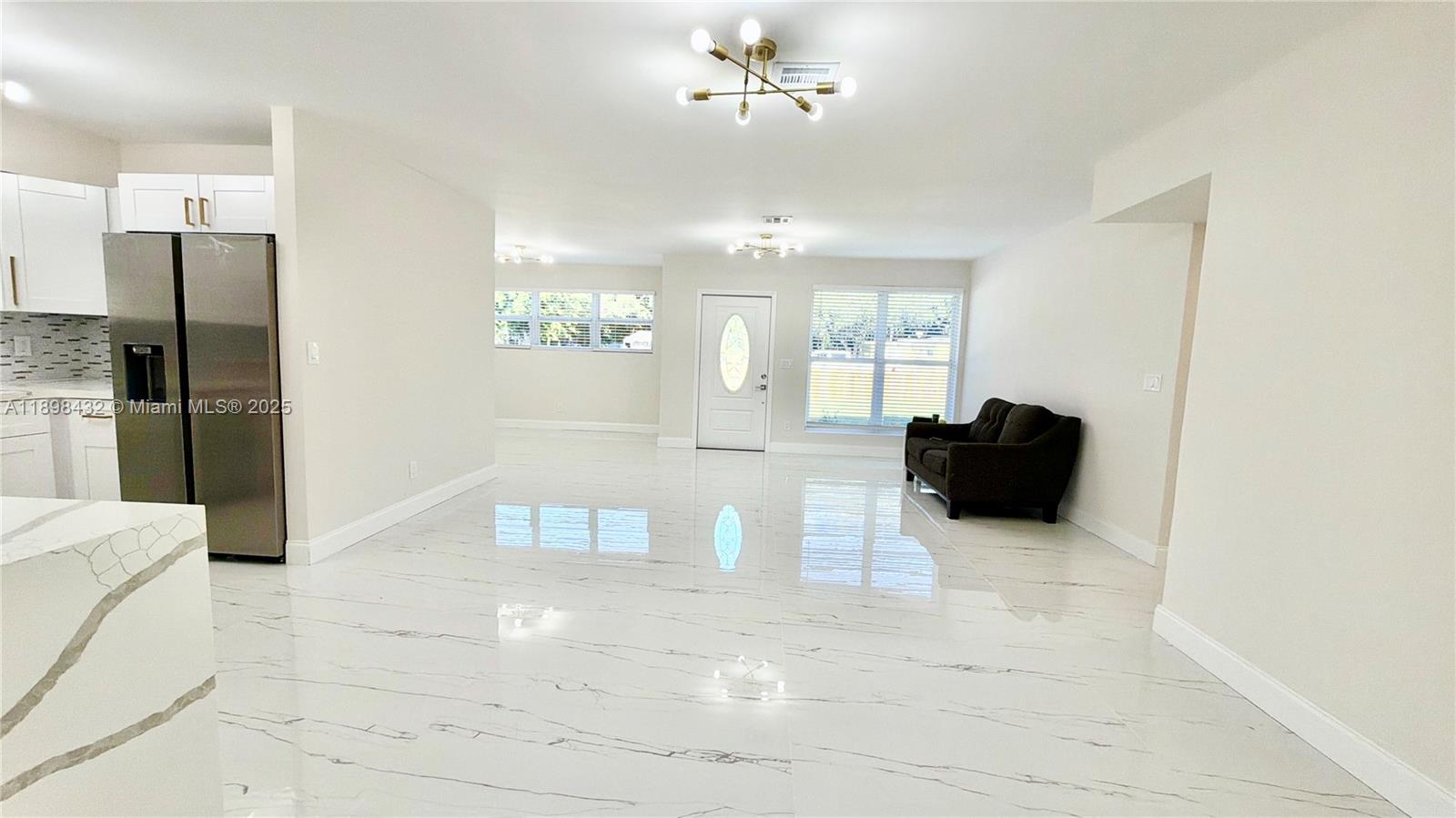 124 Harvard Road West Park, FL 33023 - Photo 7 of 75 a view of a kitchen with a sink and a refrigerator