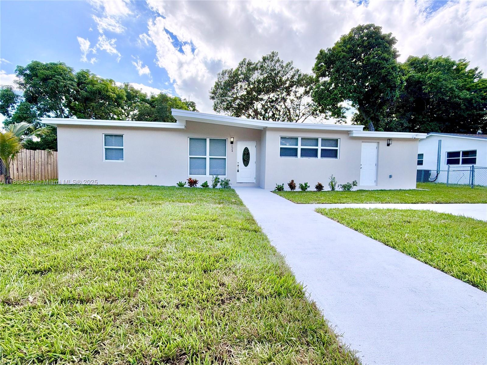 124 Harvard Road West Park, FL 33023 - Photo 71 of 75 a view of a yard in front of a house with large trees