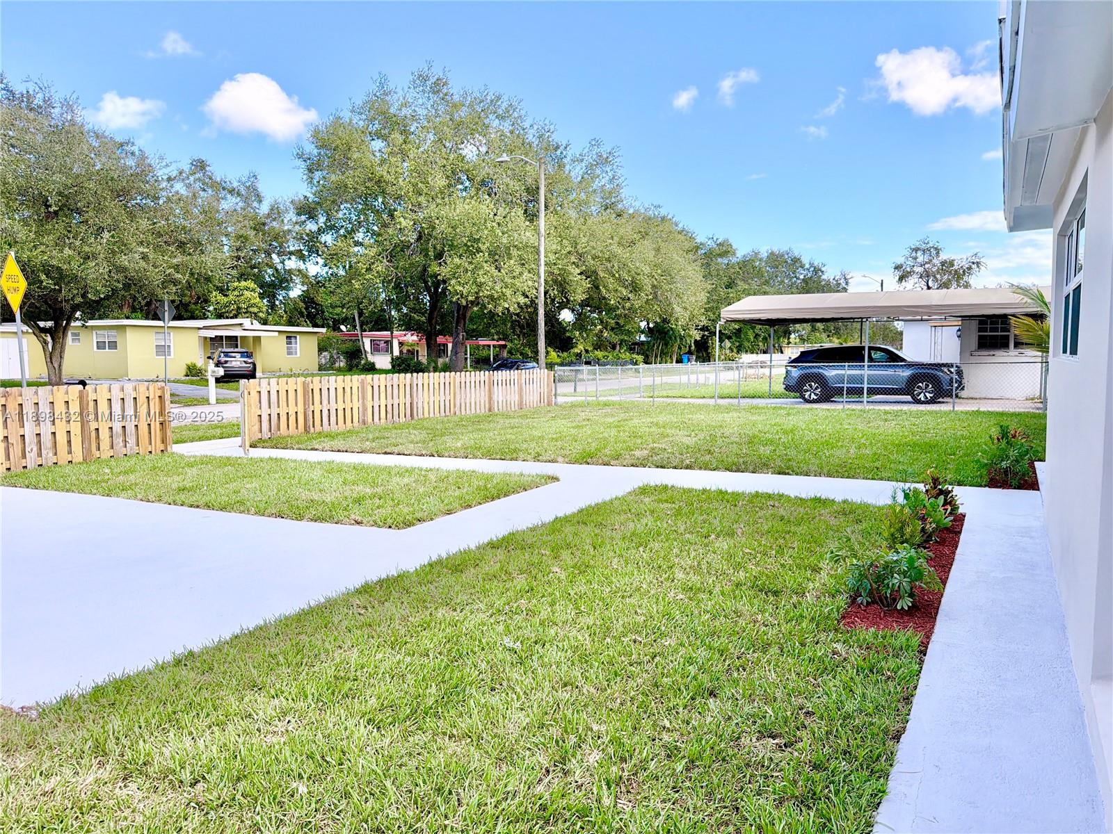 124 Harvard Road West Park, FL 33023 - Photo 72 of 75 a view of a house with a yard and sitting area