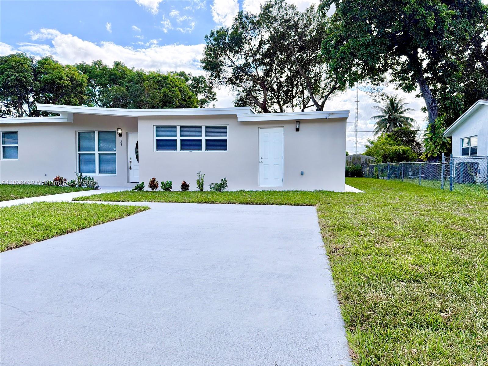 124 Harvard Road West Park, FL 33023 - Photo 75 of 75 a view of a house with a yard and a large tree