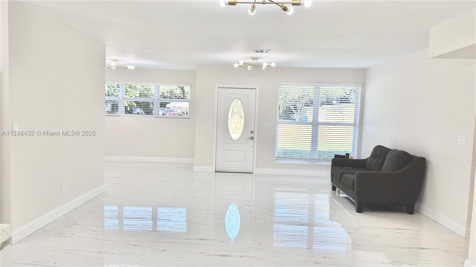 124 Harvard Road West Park, FL 33023 - Photo 9 of 75 a living room with furniture and a large window