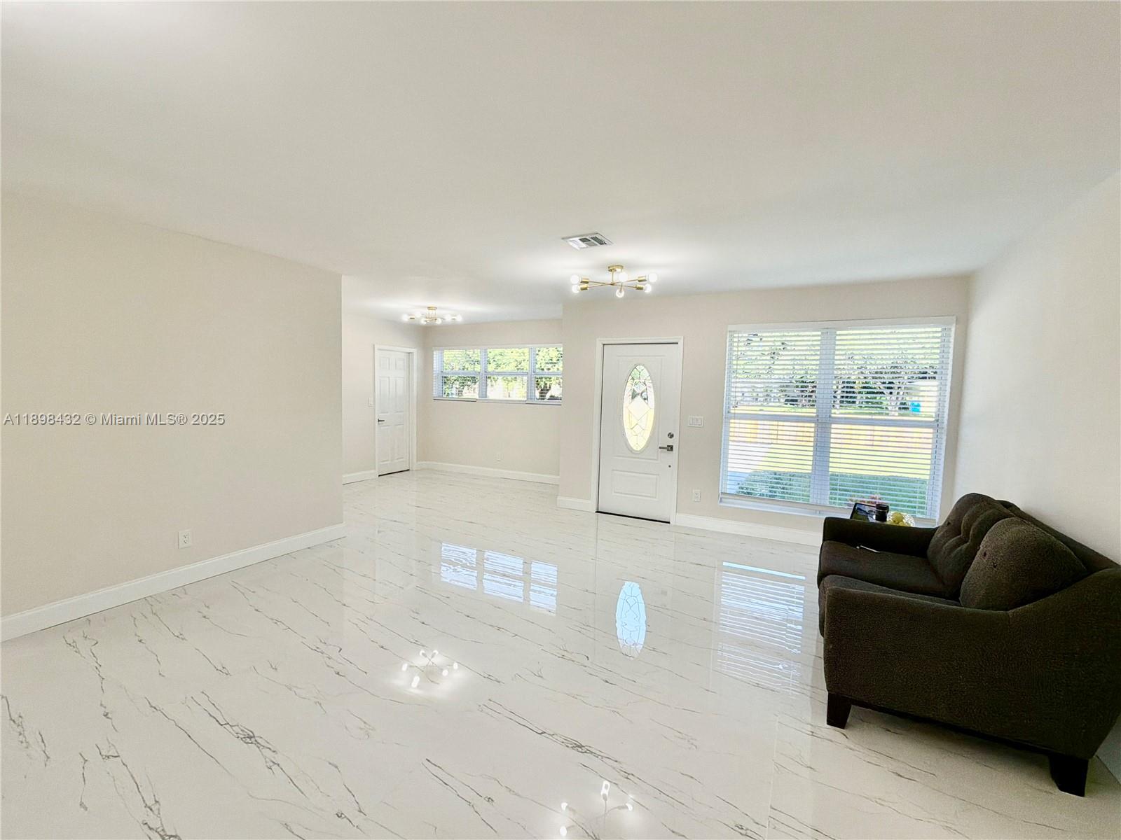 124 Harvard Road West Park, FL 33023 - Photo 10 of 75 a living room with furniture and a large window