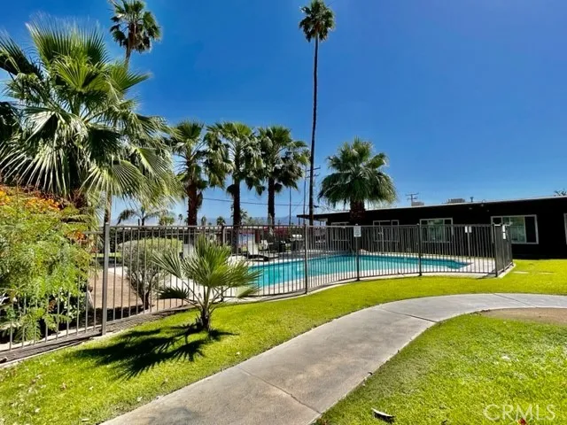 a view of a swimming pool with a table and chairs