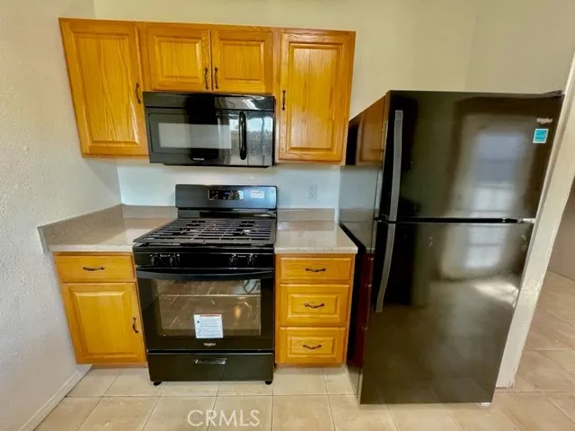 a kitchen with stainless steel appliances wooden cabinets and a stove top oven