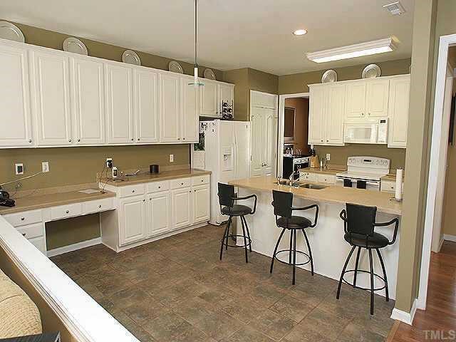 7716 Cloudview Lane Raleigh, NC 27613 - Photo 3 of 8 a kitchen with a sink cabinets and window