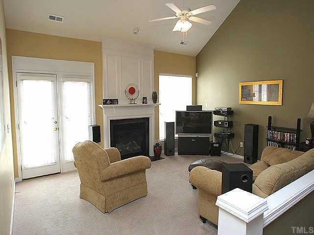 7716 Cloudview Lane Raleigh, NC 27613 - Photo 4 of 8 a living room with furniture and a fireplace