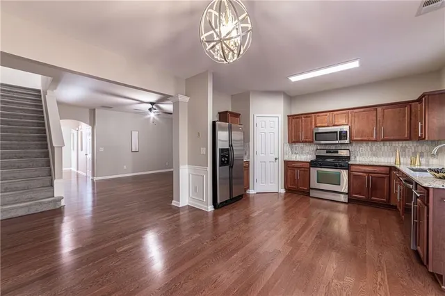 a kitchen with stainless steel appliances and wooden cabinets