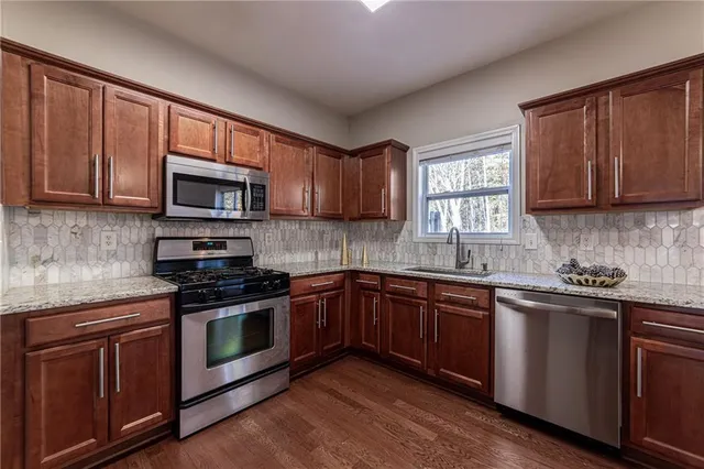 a view of a storage and utility room with wooden floor and cabinet