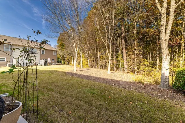 a view of hallway with furniture and wooden floor