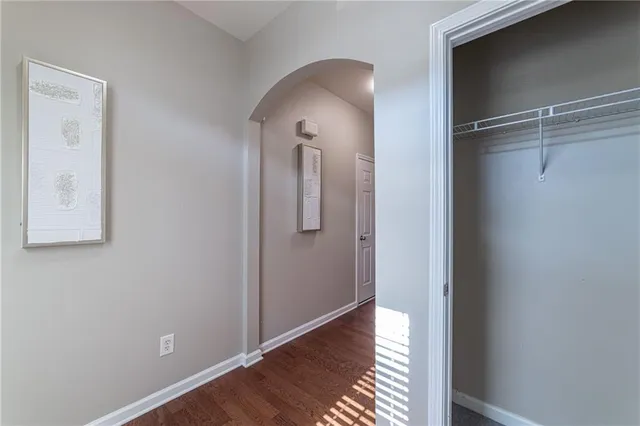 a view of a room with wooden floor