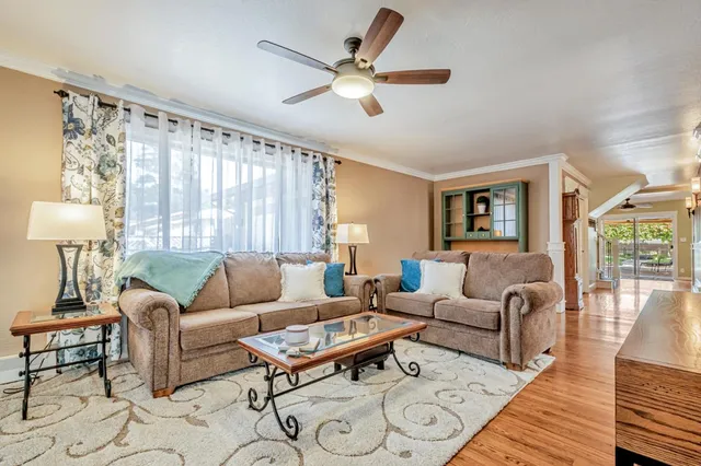 a view of a hallway with wooden floor and furniture