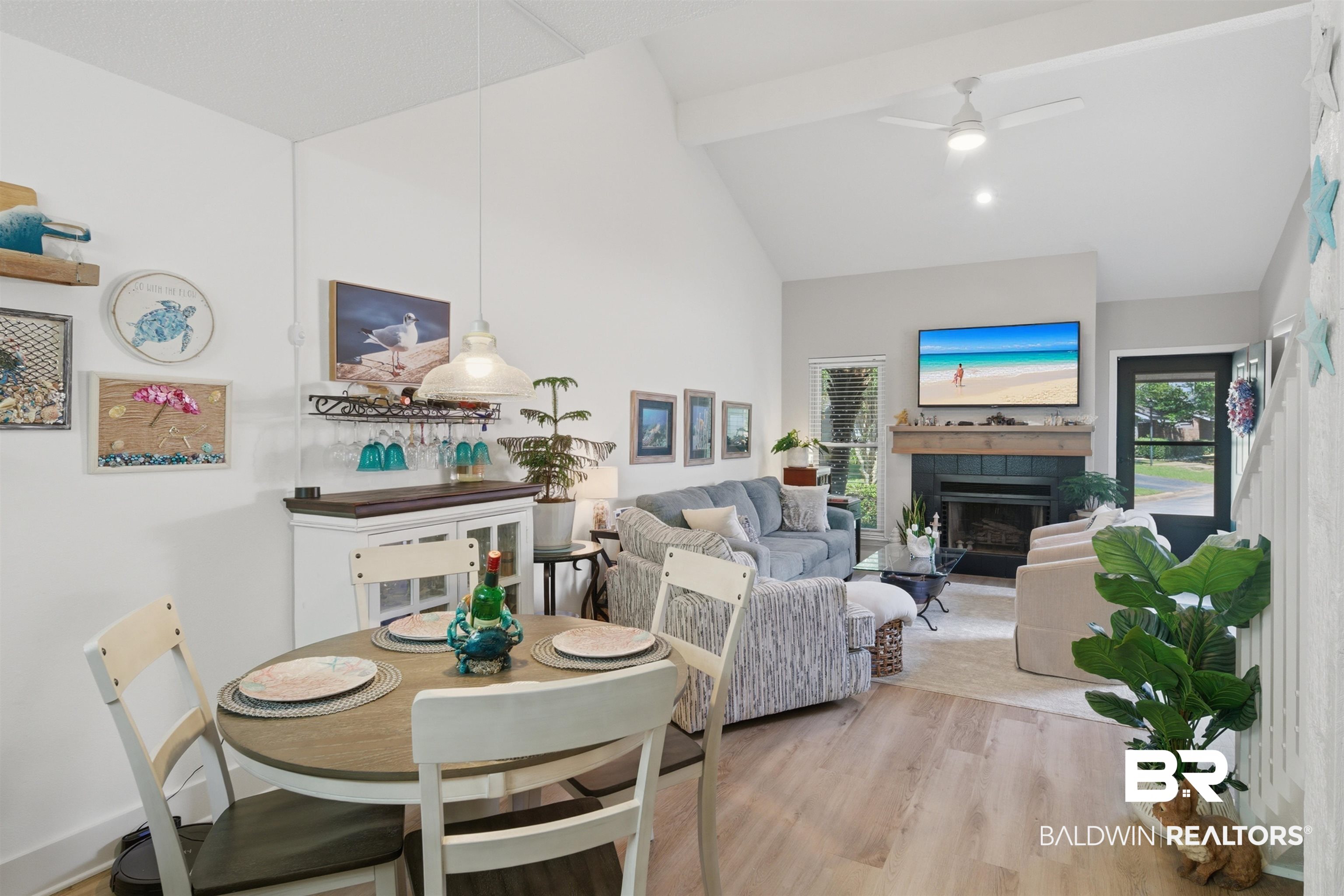389 Clubhouse Drive, Unit 5H Gulf Shores, AL 36542 - Photo 3 of 43 Bright and open with LVP floors, vaulted ceilings and a fireplace.