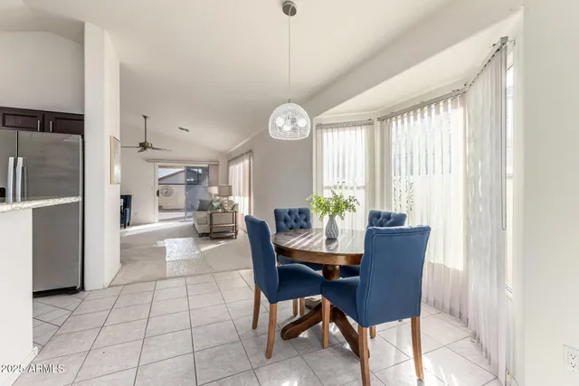 a bathroom with a granite countertop toilet sink and mirror