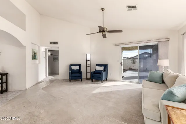 a view of a house with backyard and sitting area