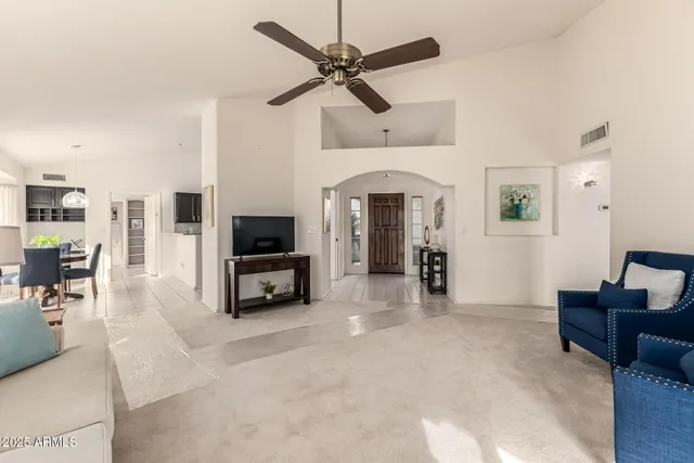 a view of a lake with a yard and large trees