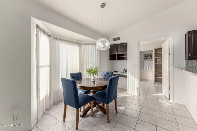 a kitchen with granite countertop a refrigerator and a sink