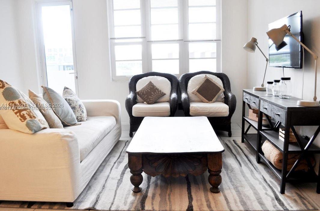 100 Lincoln Road, Unit 522 Miami Beach, FL 33139 - Photo 3 of 7 a living room with furniture rug and window