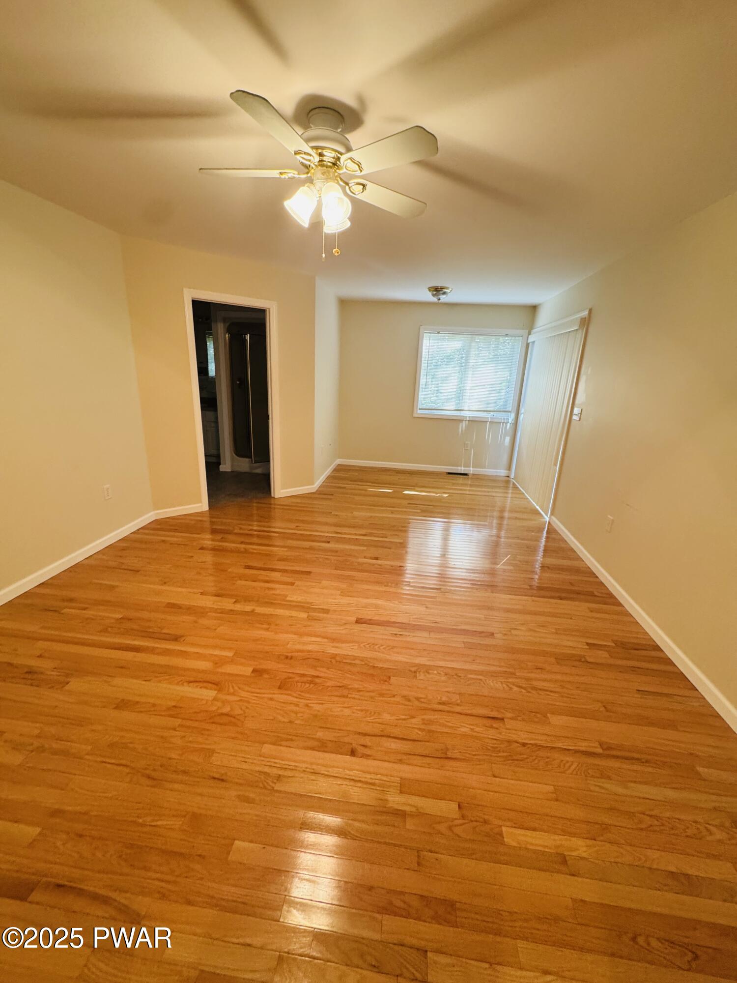 137 Rodeo Drive Hawley, PA 18428 - Photo 21 of 68 a view of an empty room with wooden floor