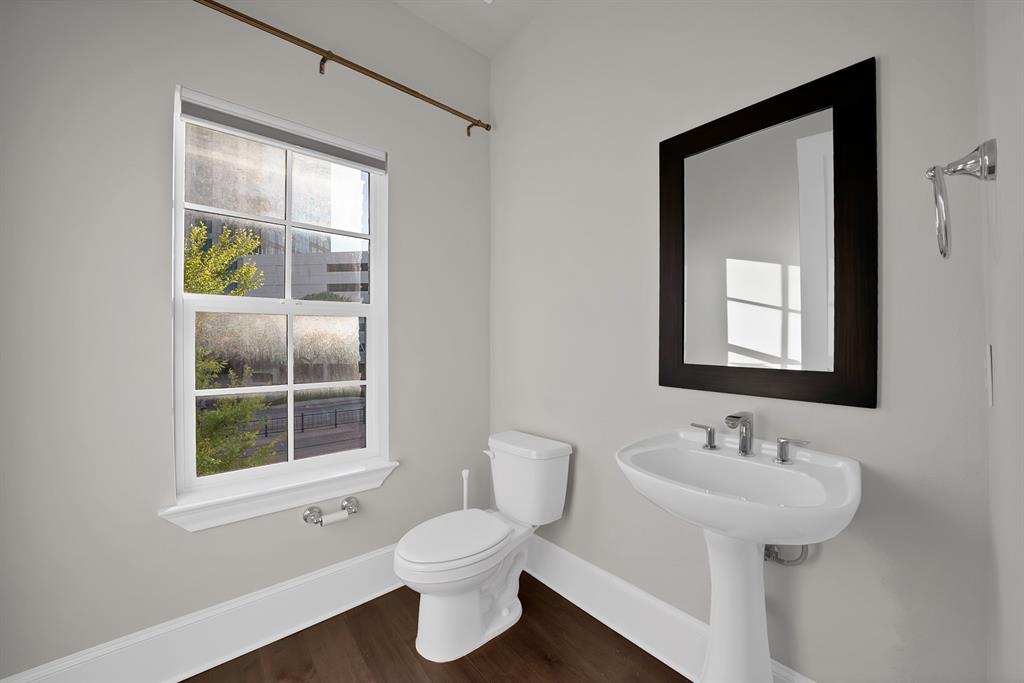 5437 Patterson Street Irving, TX 75039 - Photo 21 of 40 half Bathroom on main living floor with toilet and dark wood-type flooring