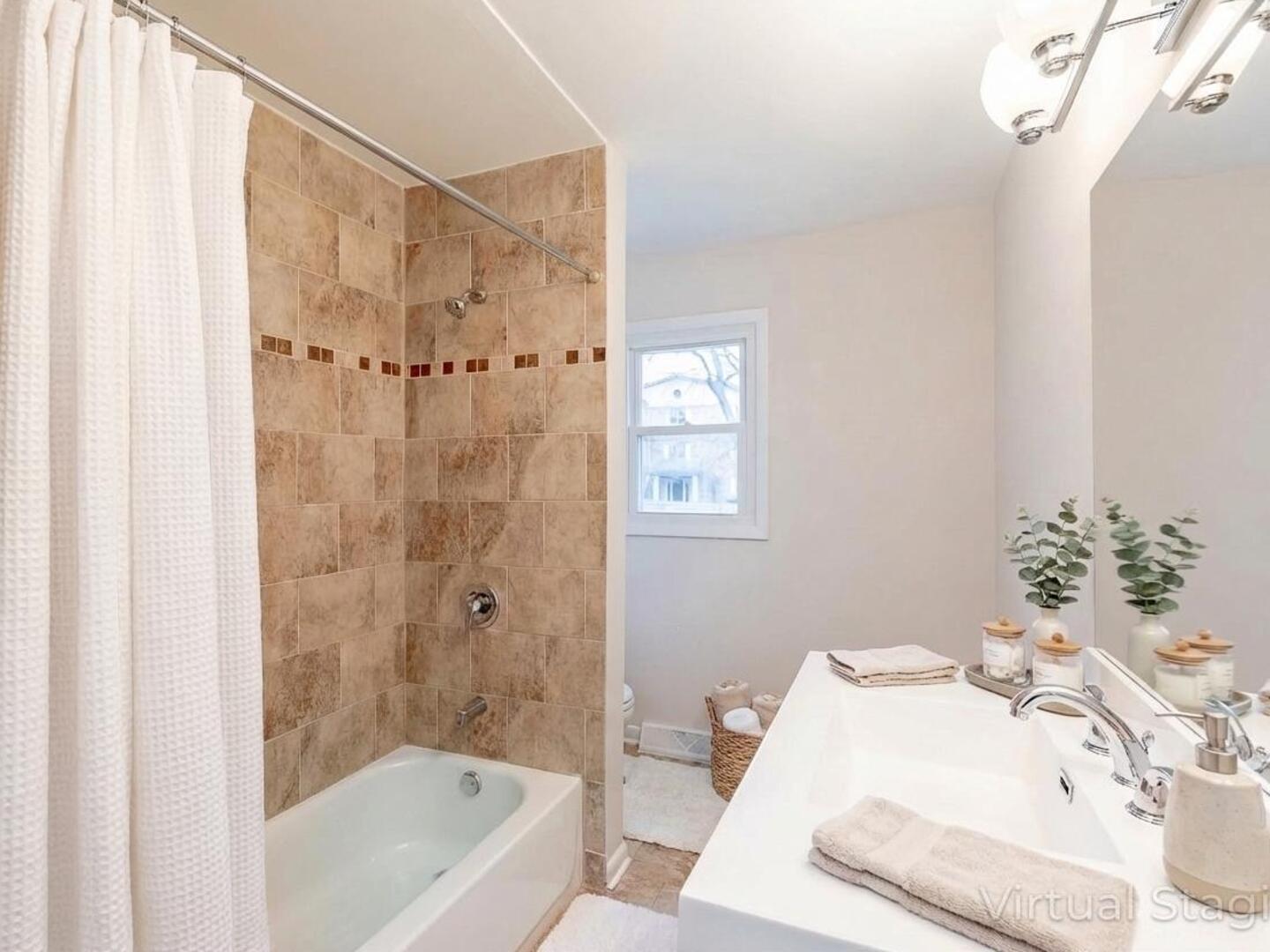 18331 Hickory Street Lansing, IL 60438 - Photo 8 of 12 a bath room with a bath tub and a shower curtain
