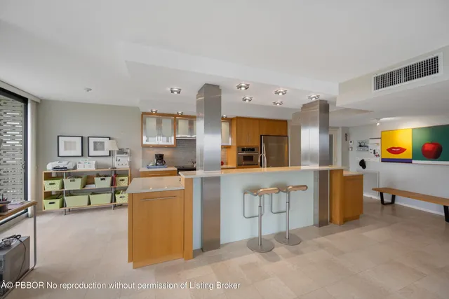 a large white kitchen with cabinets and furniture