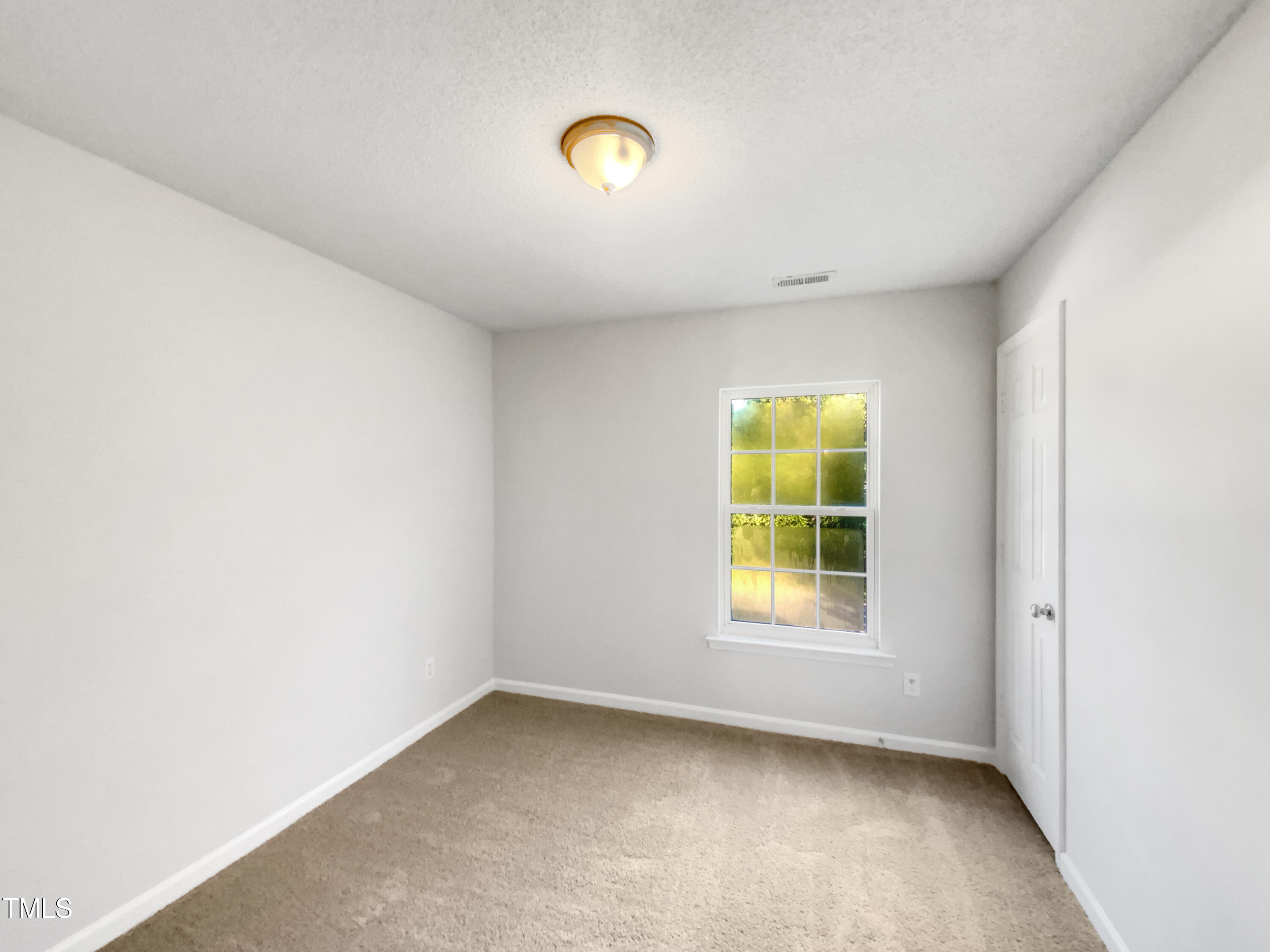 102 Spring Dove Lane Apex, NC 27539 - Photo 14 of 20 a view of an empty room with a window