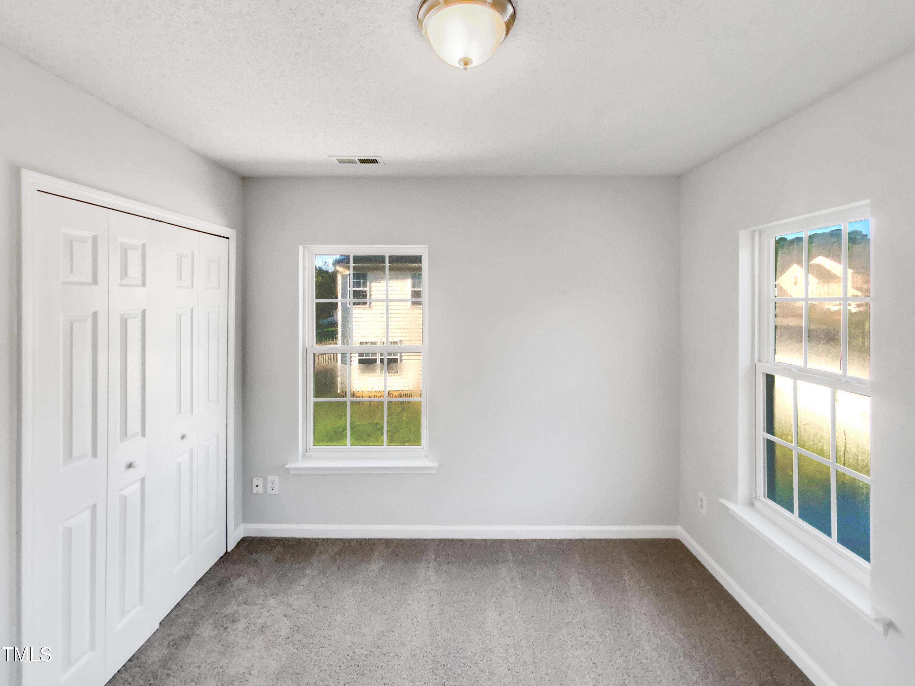 102 Spring Dove Lane Apex, NC 27539 - Photo 17 of 20 a view of an empty room with a window