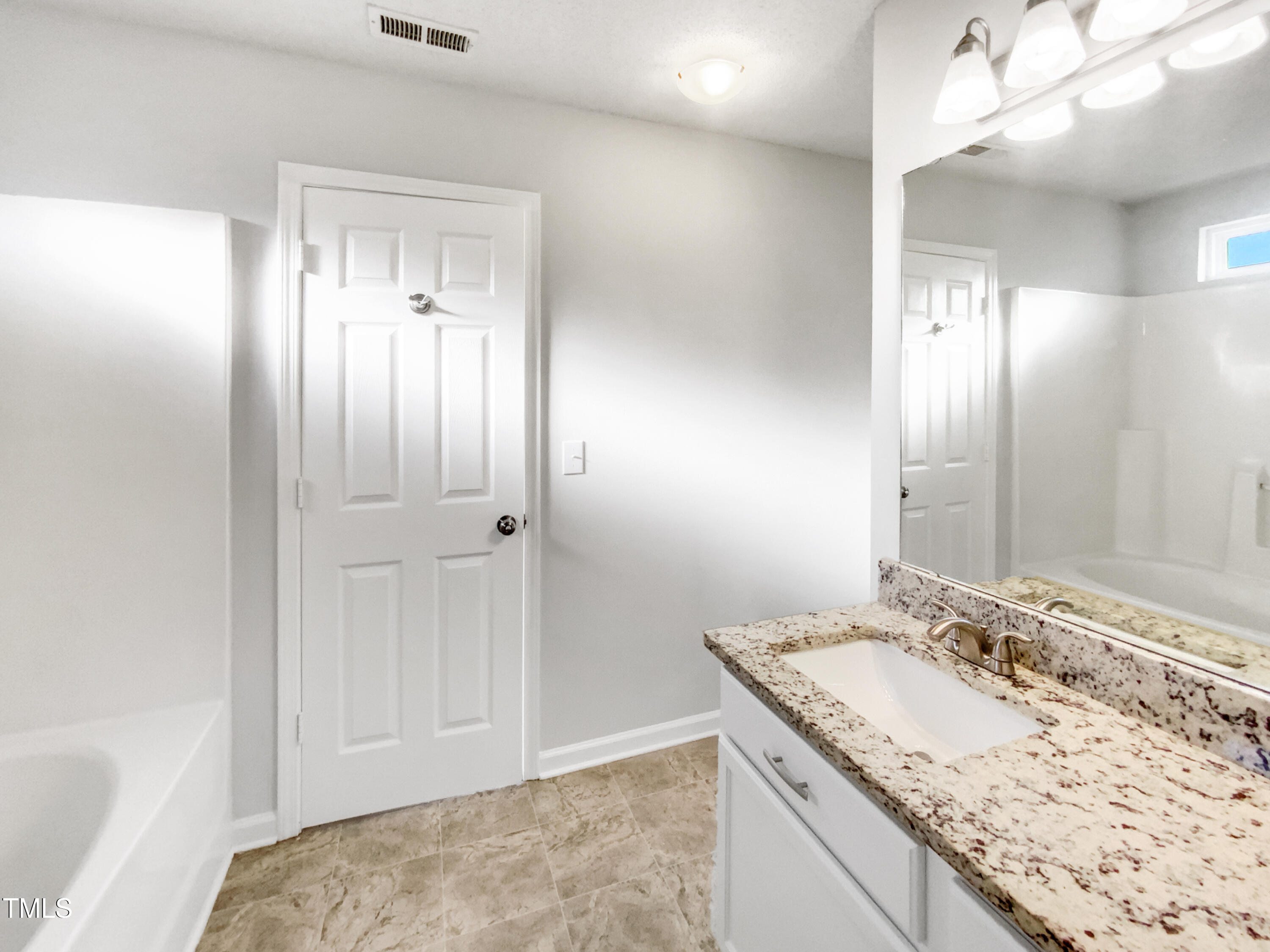 102 Spring Dove Lane Apex, NC 27539 - Photo 18 of 20 a bathroom with a granite countertop sink and a mirror