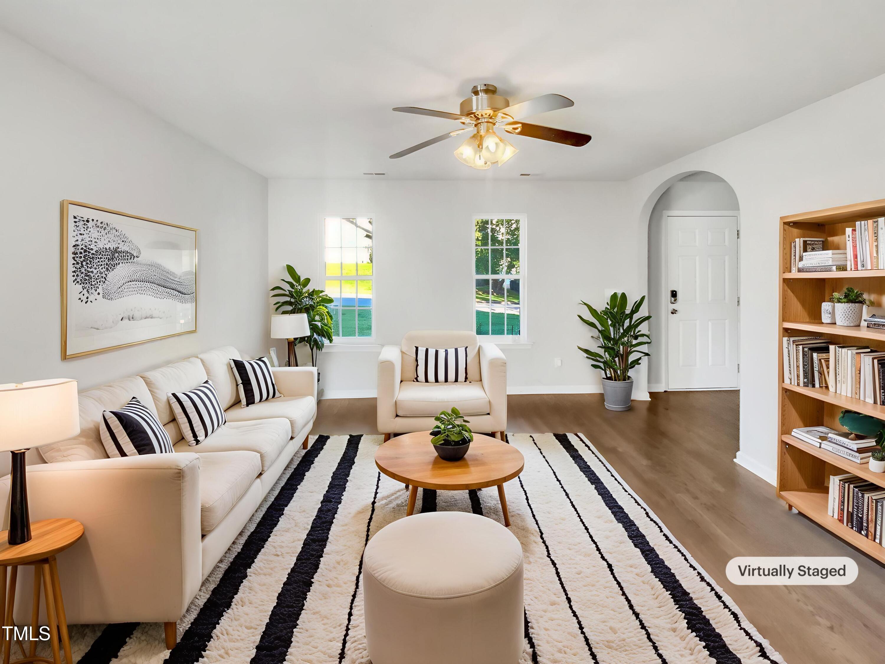 102 Spring Dove Lane Apex, NC 27539 - Photo 2 of 20 a living room with furniture and a bookshelf
