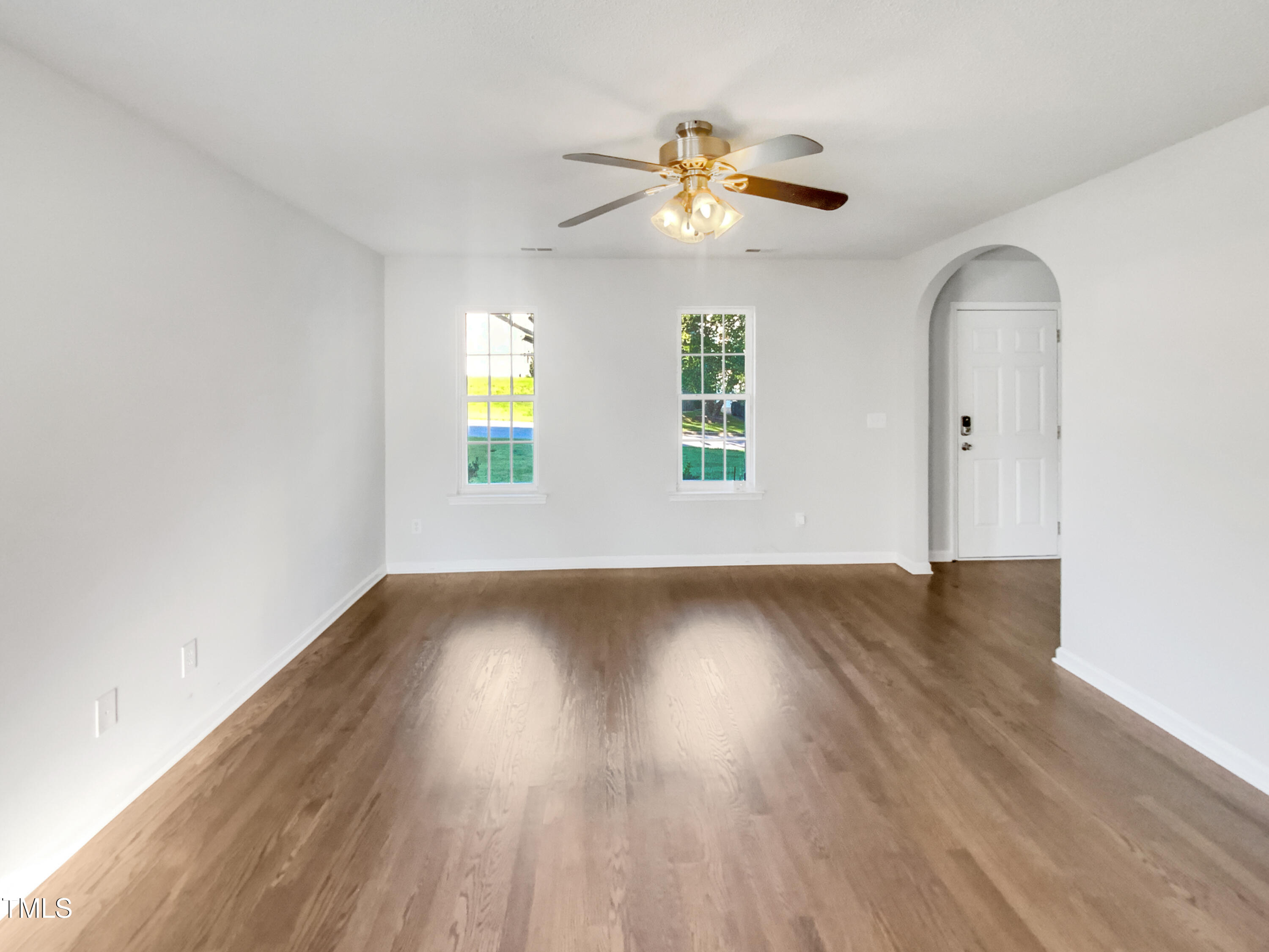 102 Spring Dove Lane Apex, NC 27539 - Photo 3 of 20 a view of an empty room with wooden floor and window
