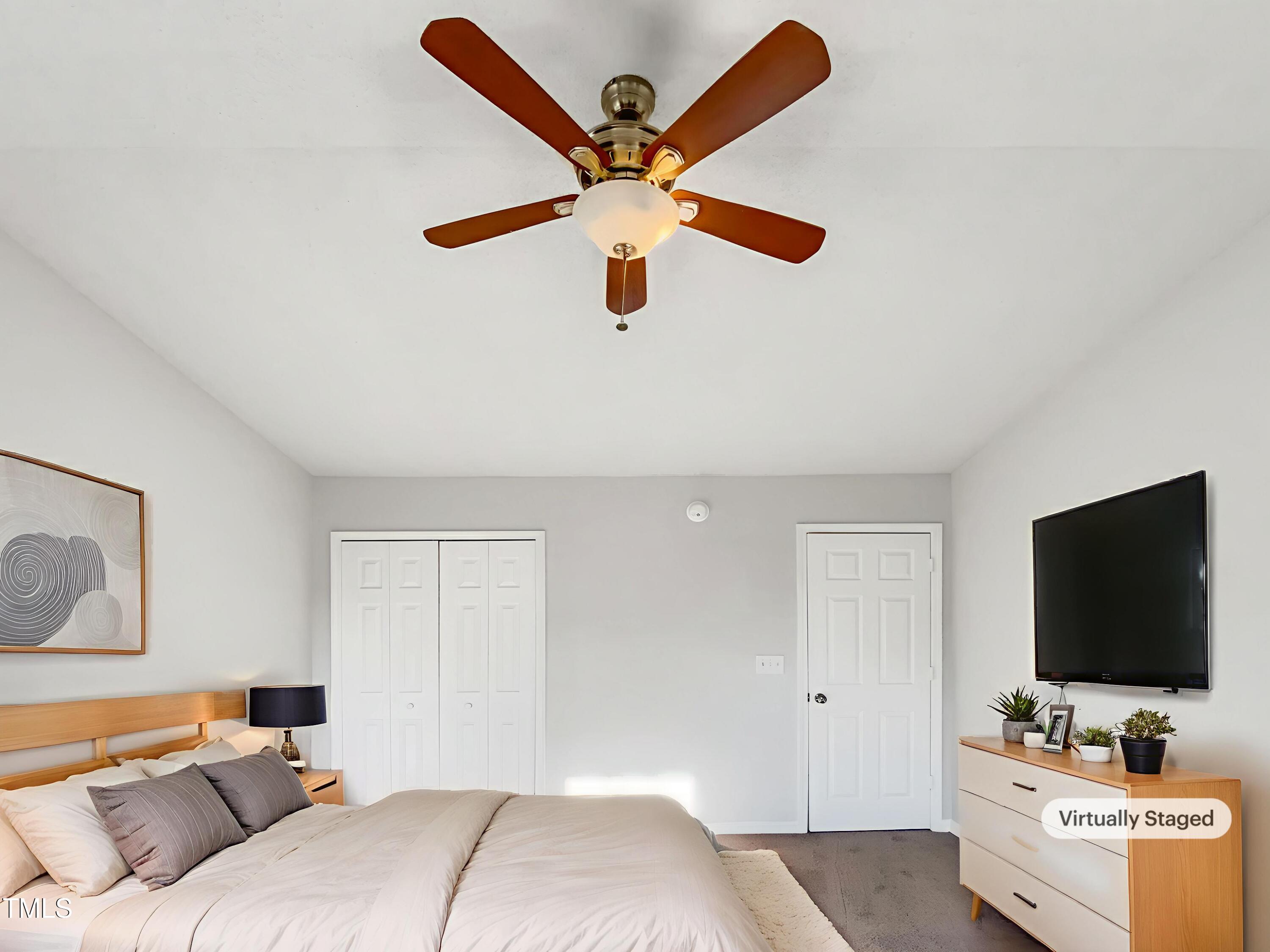 102 Spring Dove Lane Apex, NC 27539 - Photo 4 of 20 a bedroom with a bed and a flat screen tv