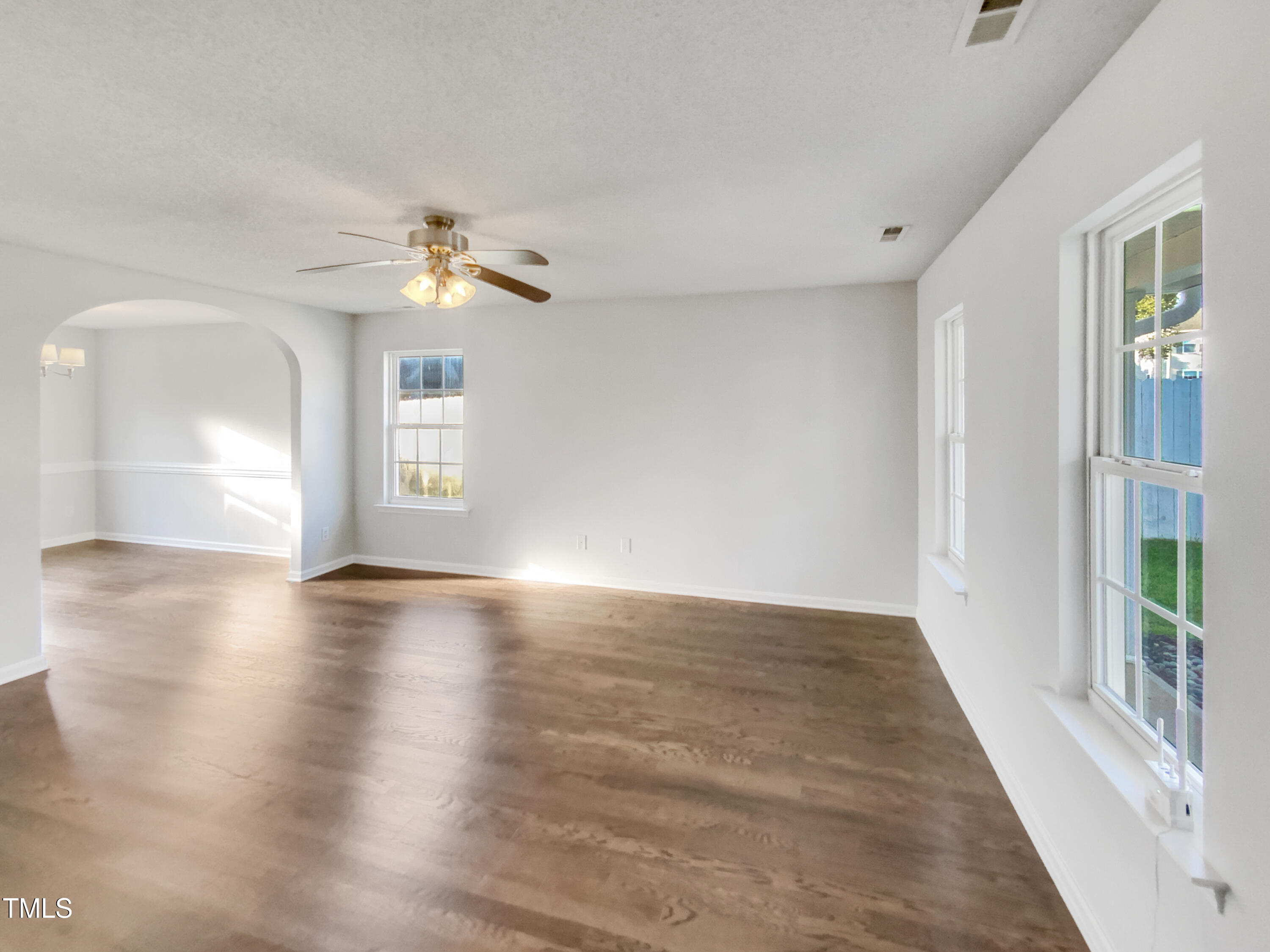 102 Spring Dove Lane Apex, NC 27539 - Photo 9 of 20 wooden floor in an empty room with a window