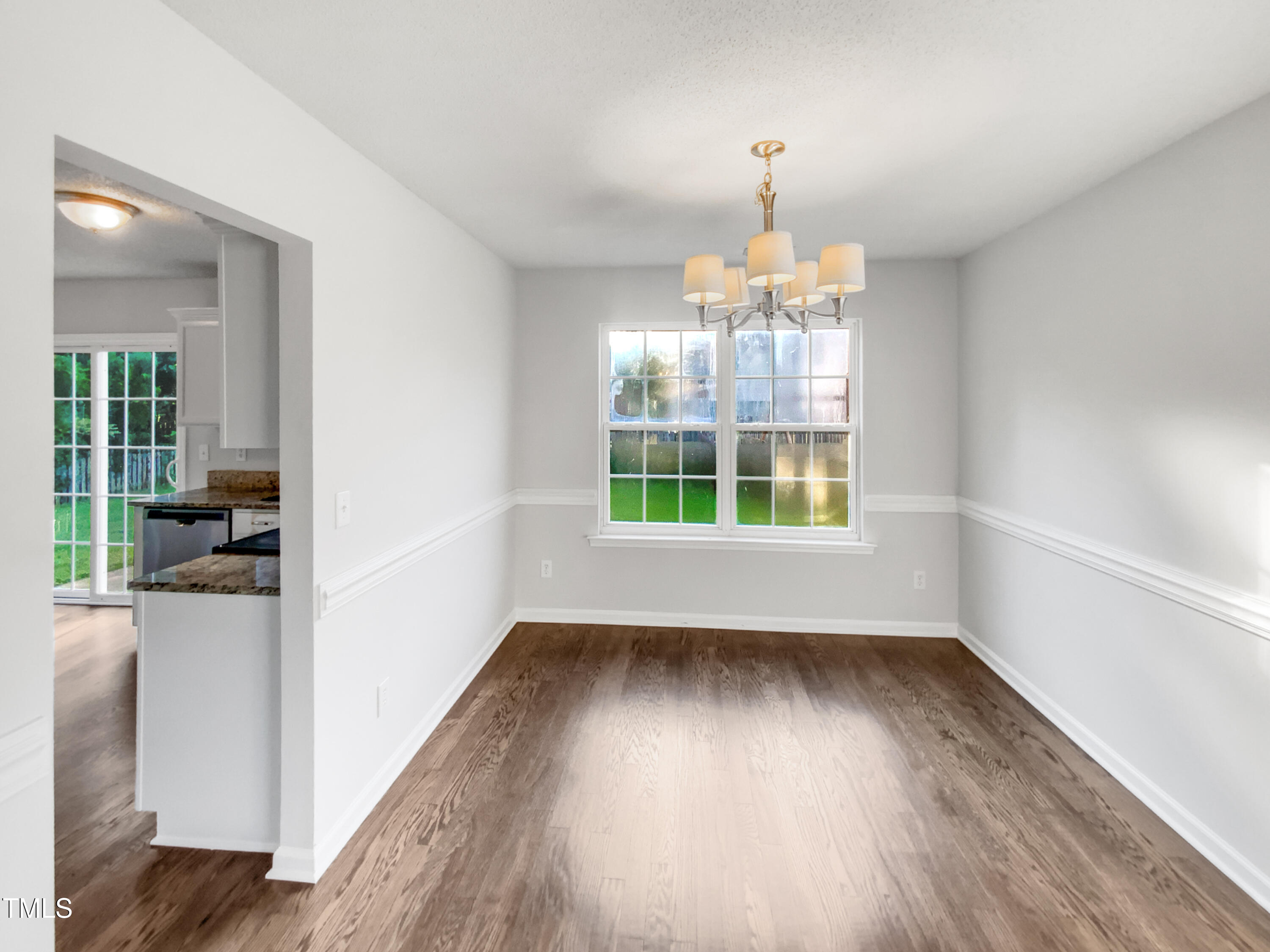 102 Spring Dove Lane Apex, NC 27539 - Photo 10 of 20 wooden floor in an empty room with a window